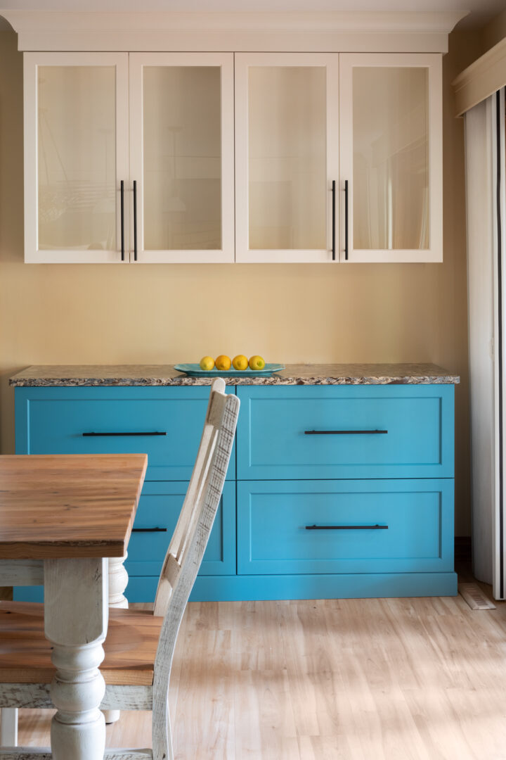A kitchen countertop with blue cabinetry